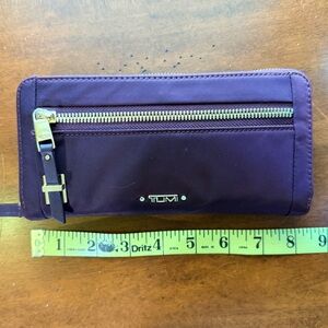 Tumi Maroon Wallet with Gold Zipper and Leather Accents